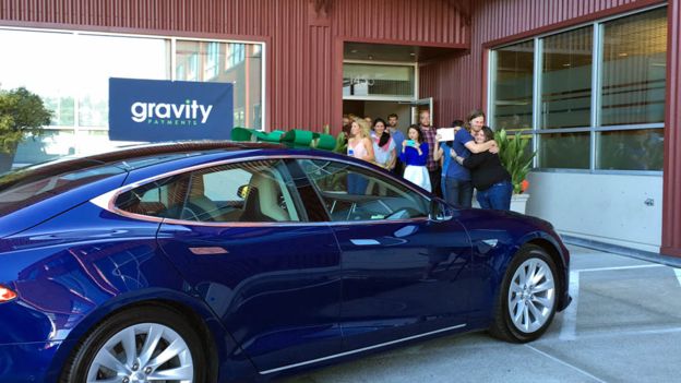 Dan Price acepta un auto Tesla.